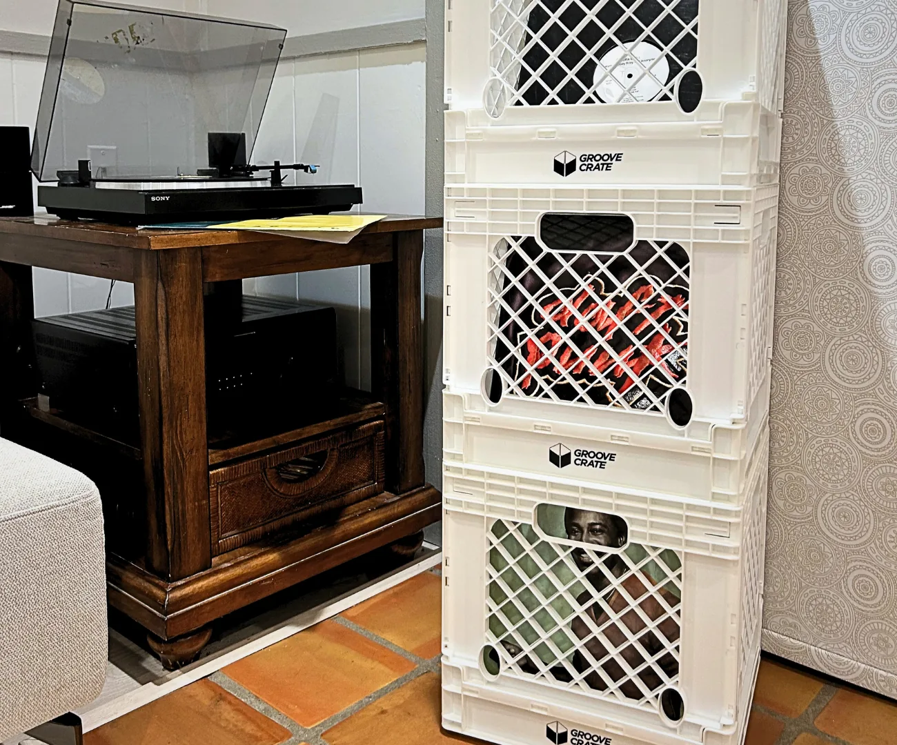 Groove Crates stacked three high and filled with records beside a turntable